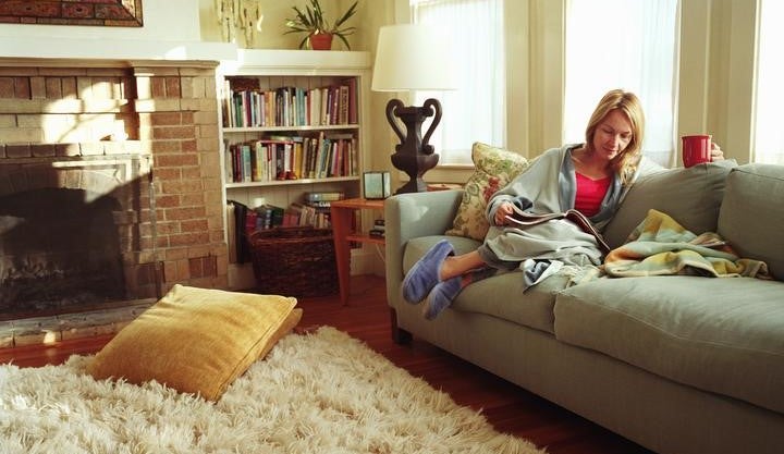Woman enjoying a cup of tea on the sofa